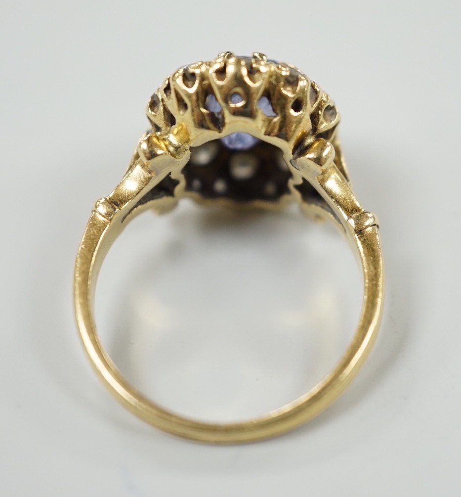 An early to mid 20th century yellow metal, sapphire and diamond set oval cluster dress ring, size